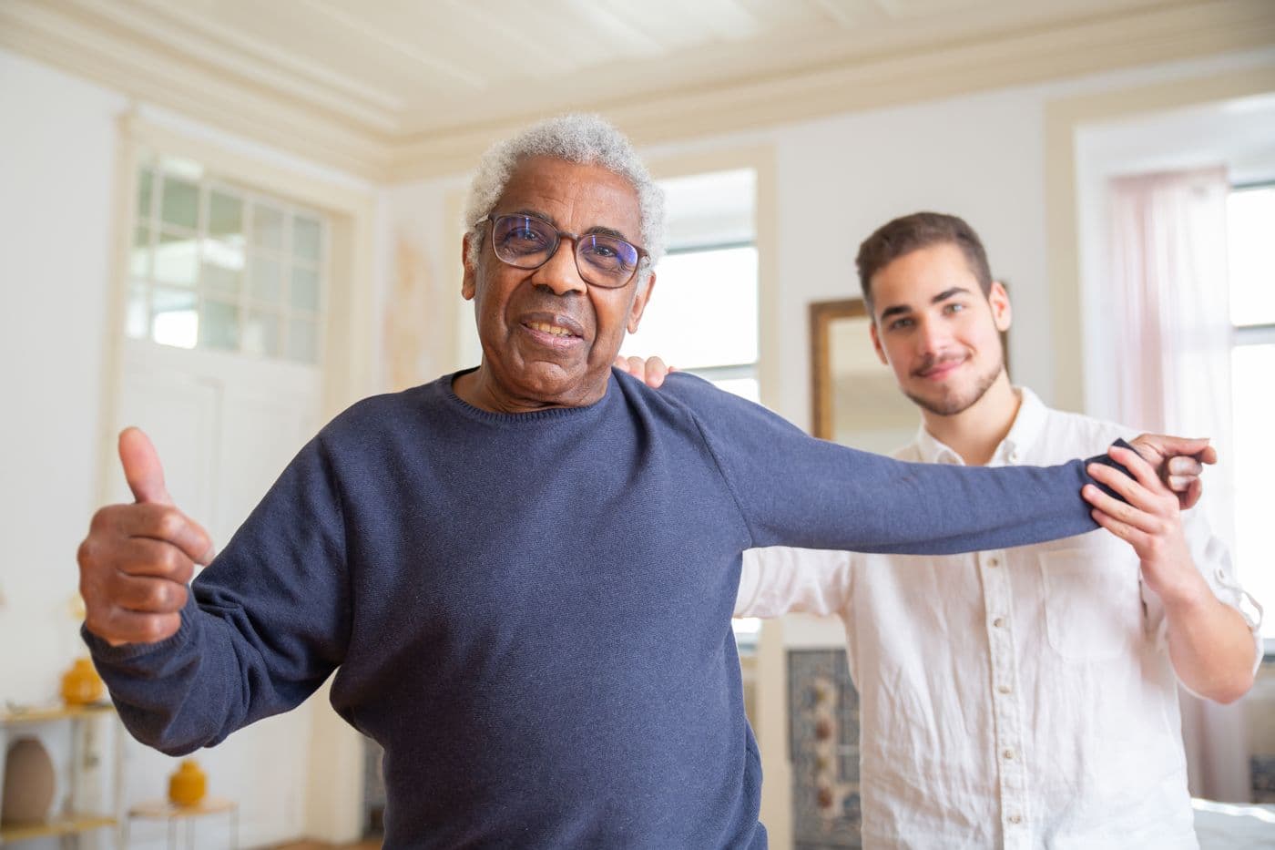 Caregiver helping a senior with recovery exercises after returning home