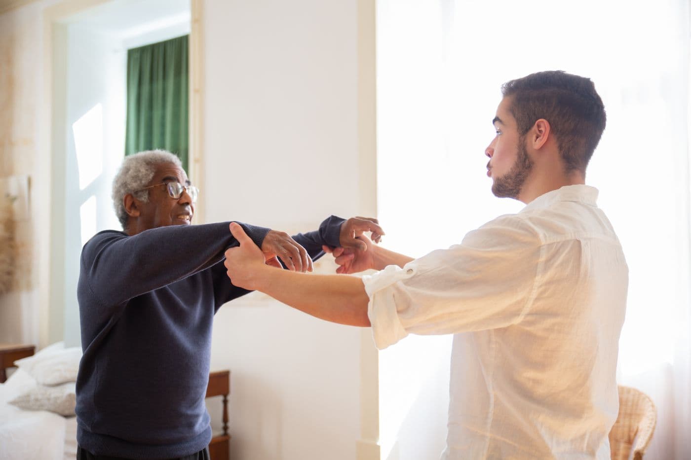 Caregiver walking with a senior resident and offering everyday support
