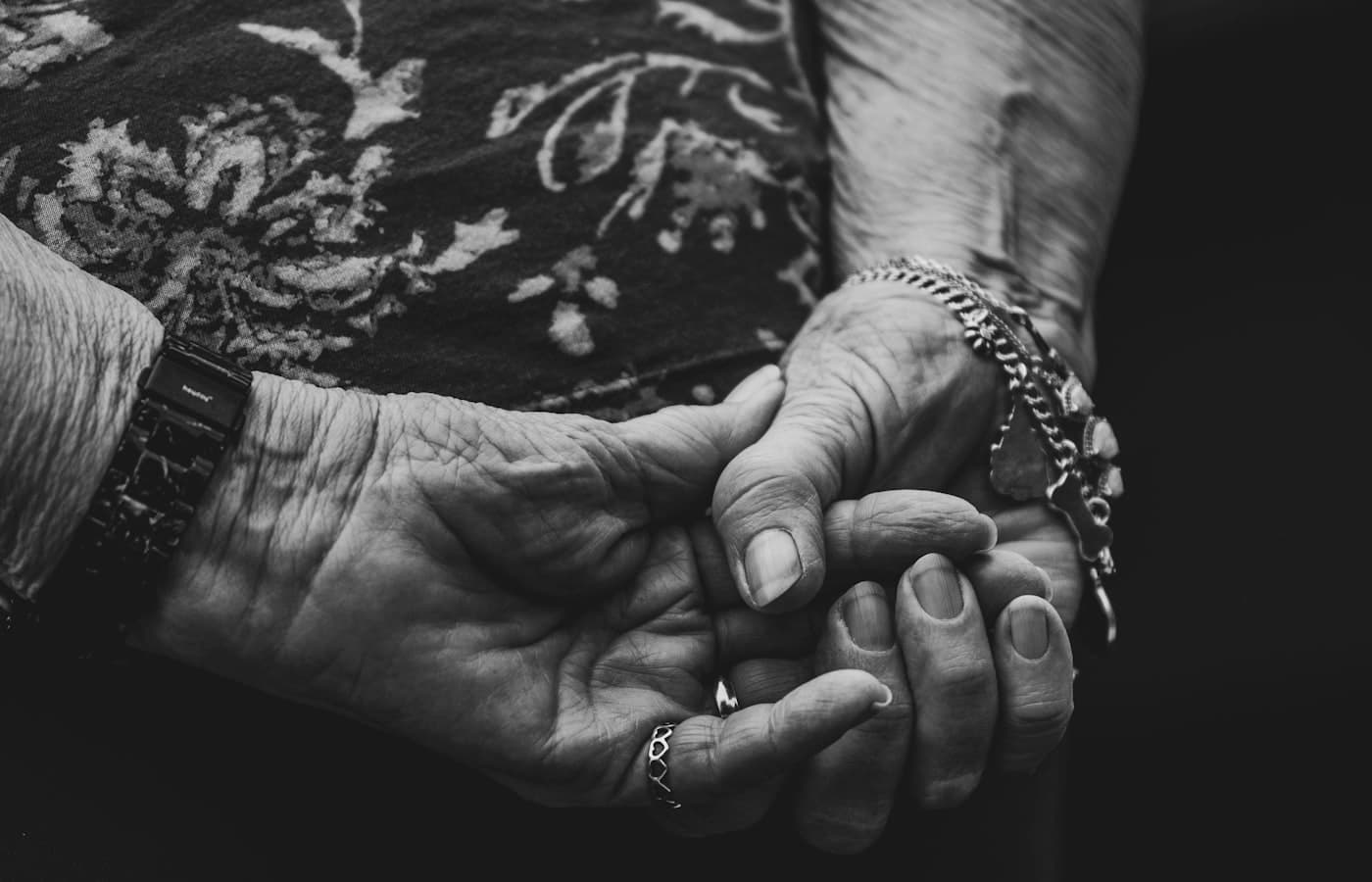 Younger family member holding an older loved one’s hand in quiet support