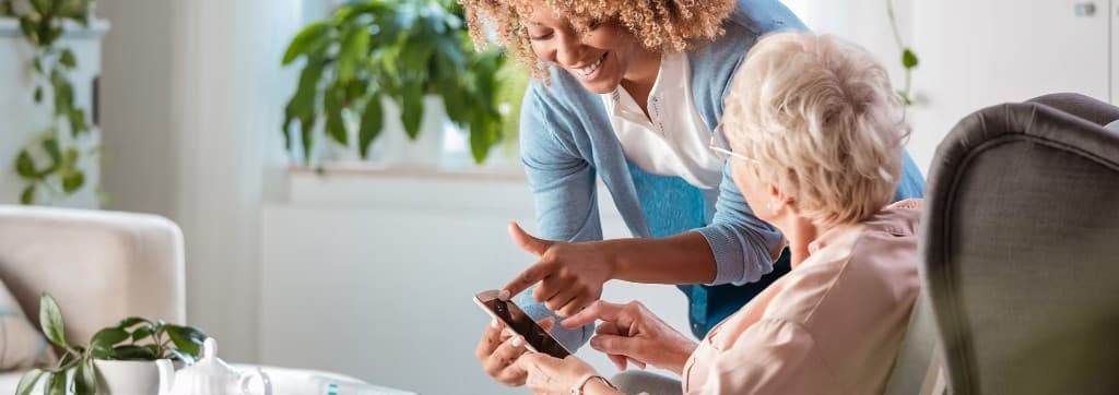 Caregiver helping a senior resident in an independent living community